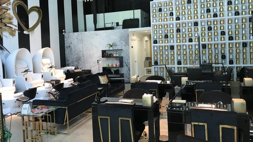 Nail salon station with manicure tools and polish bottles.